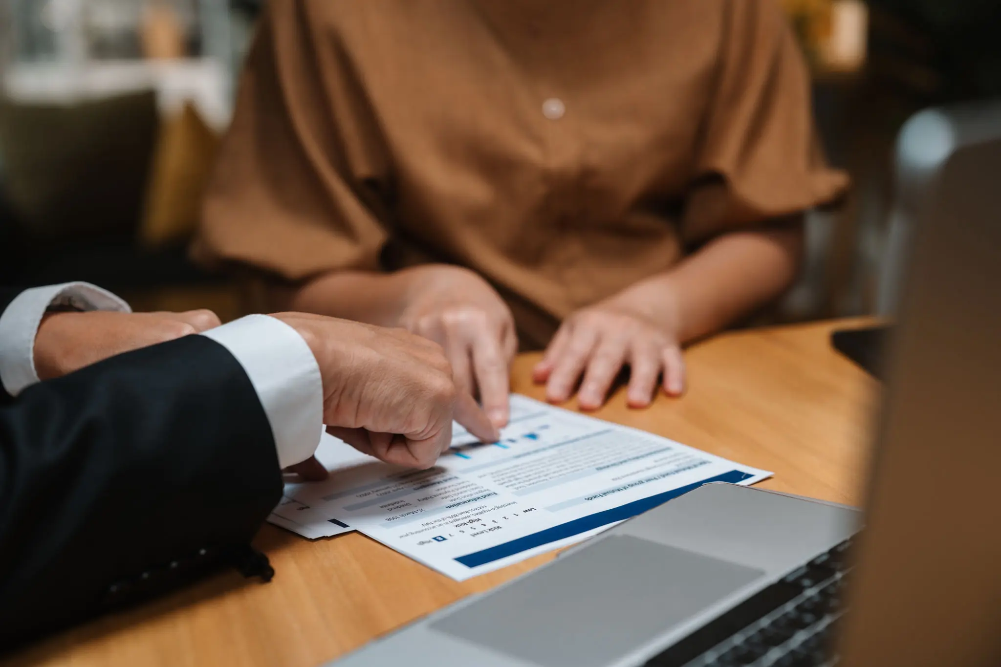 Hands pointing at a document