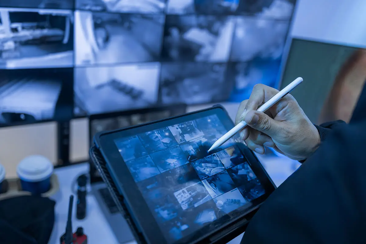 Person using tablet with security cameras