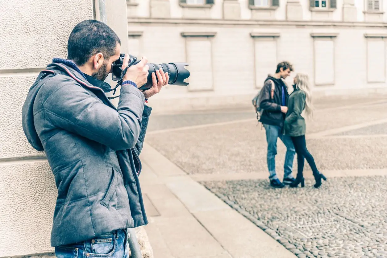 Man photographing couple from a distance