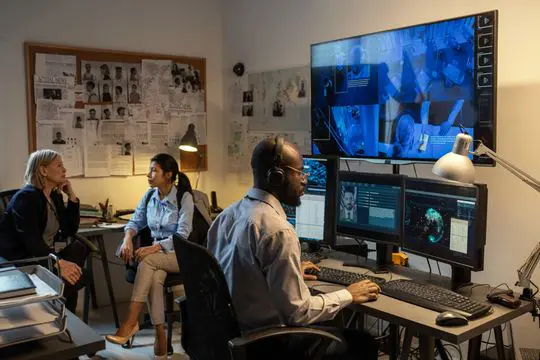 Detectives analyzing data in a control room